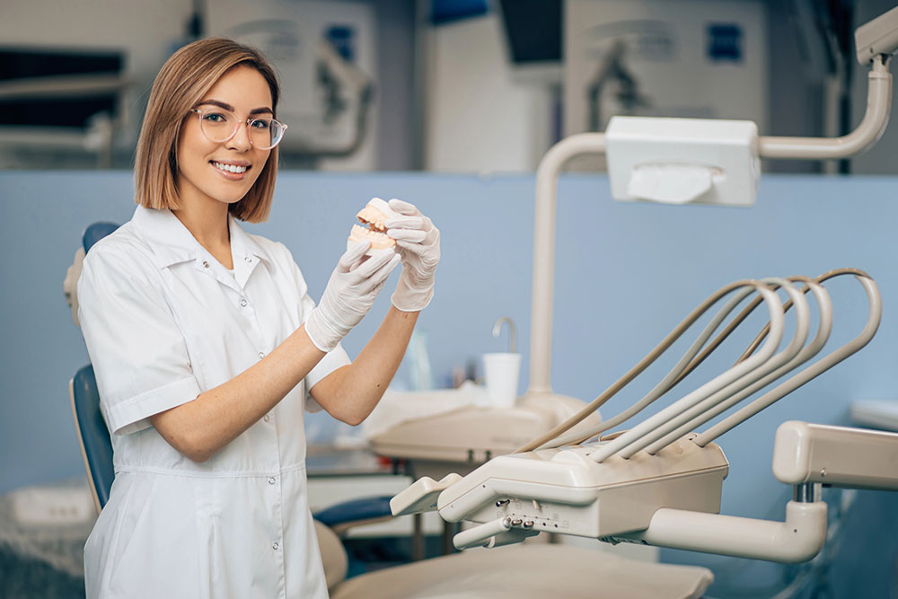 Young dentist woman in dental office