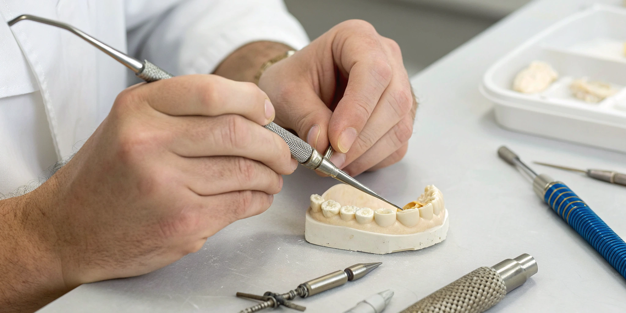 Technician crafting PFM and zirconia crowns with precision tools in the best dental lab.